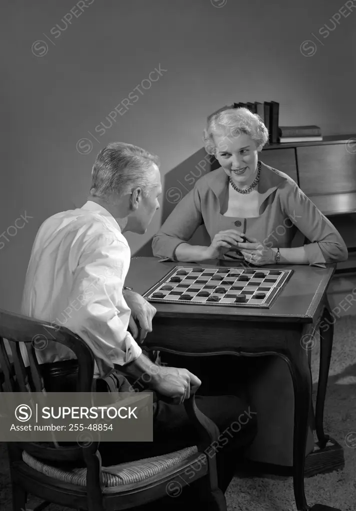 Mature couple playing board game