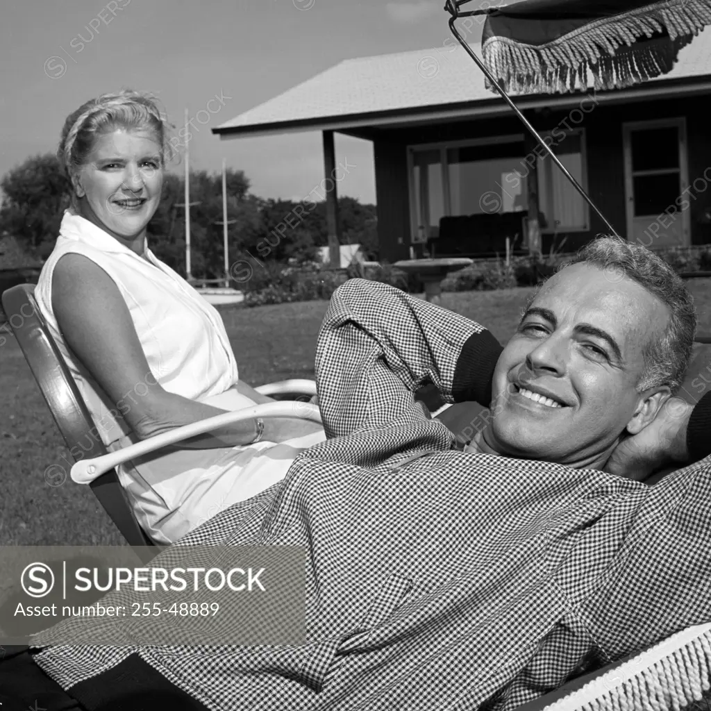 Mature couple relaxing in backyard