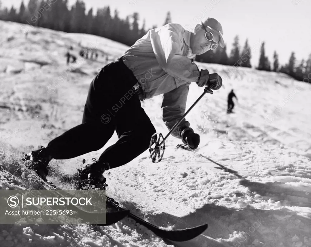 Mid adult man skiing downhill