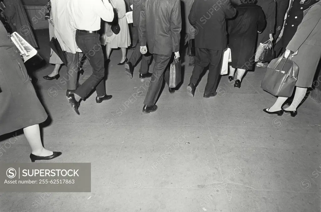 Vintage Photograph. Walking feet on sidewalk.