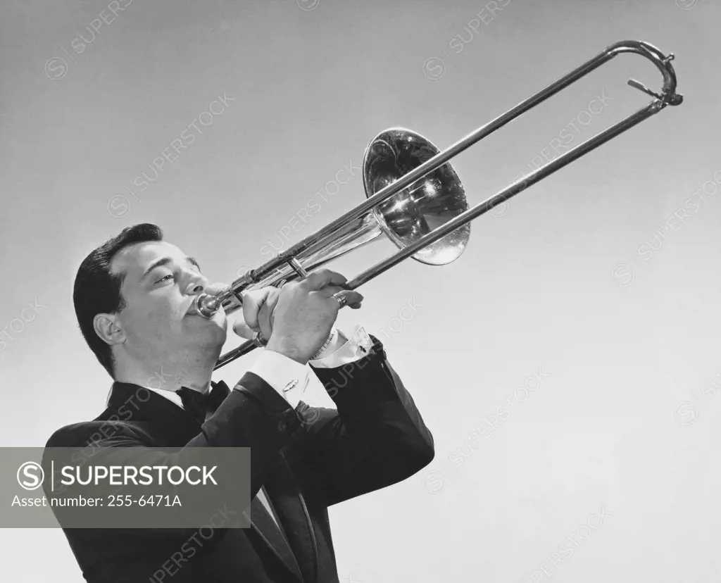 Mid adult man playing a trombone