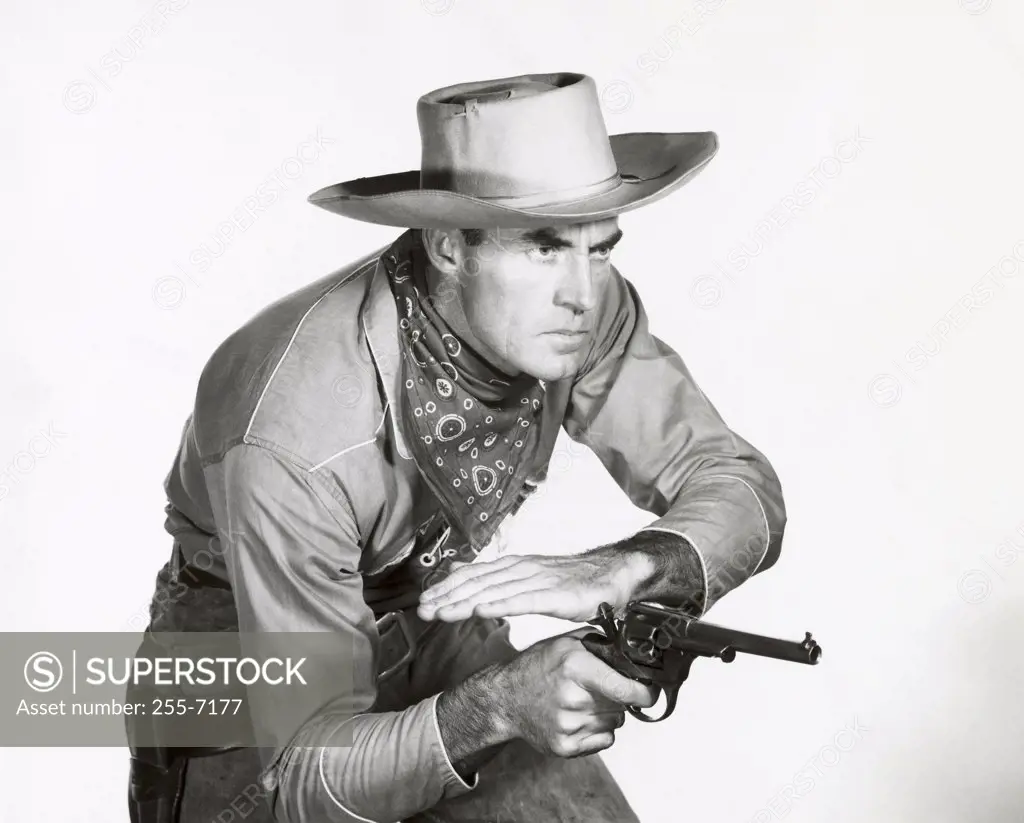 Close-up of a cowboy cocking his pistol