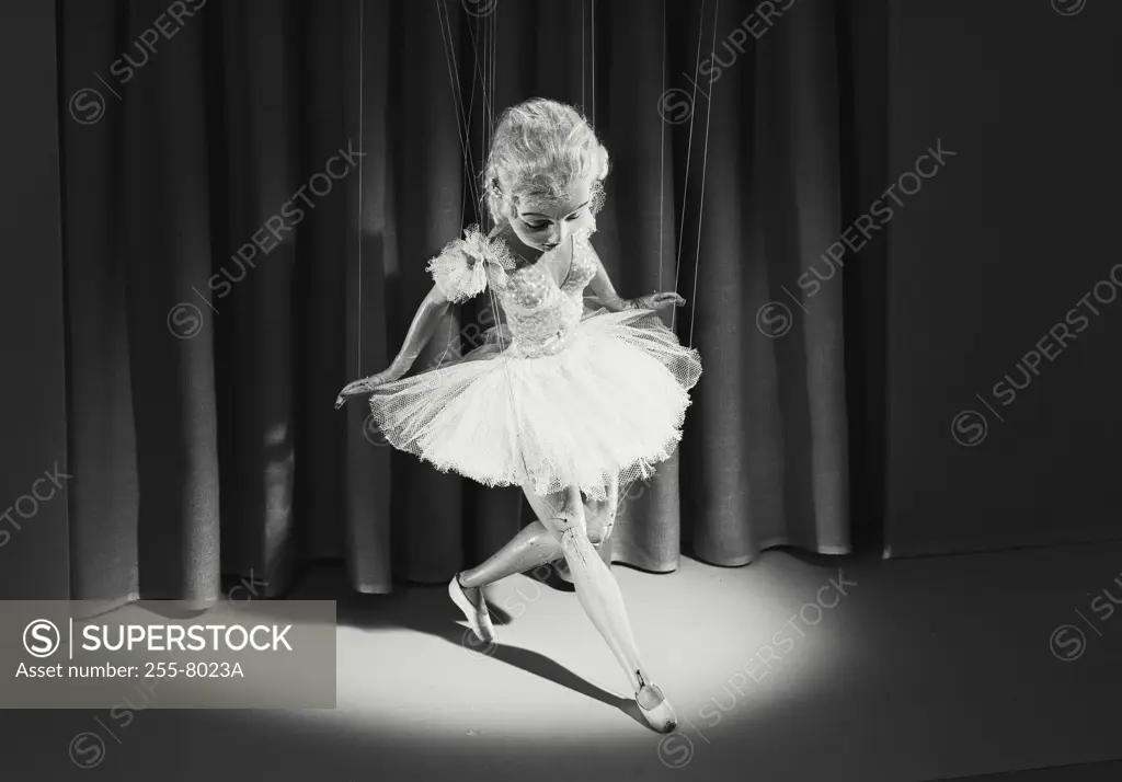 Vintage photograph. High angle view of a female marionette dancing