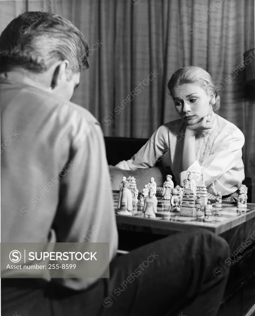 Couple playing chess at home