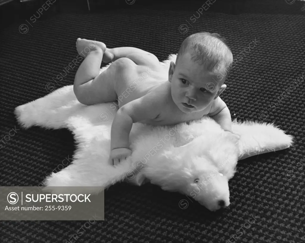 Baby lying on a bearskin rug