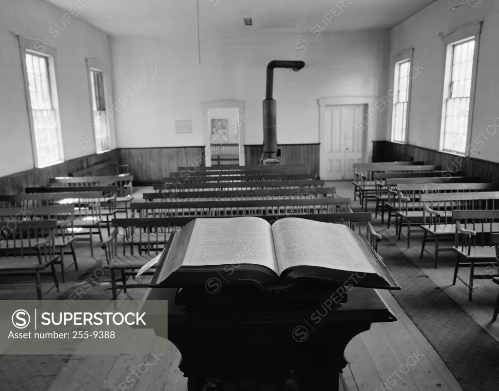 Close-up of an open book on a lectern in a classroom