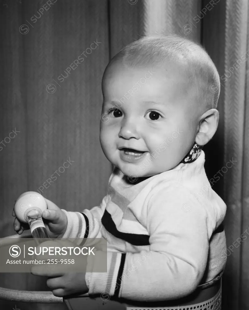 Portrait of smiling baby holding toy