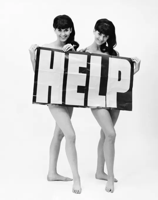 Nude twin young women holding a Help sign