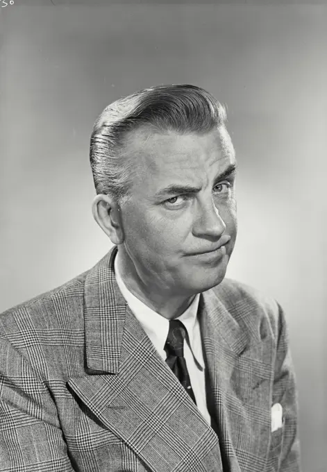 Vintage photograph. Portrait of Businessman with raised eyebrow.