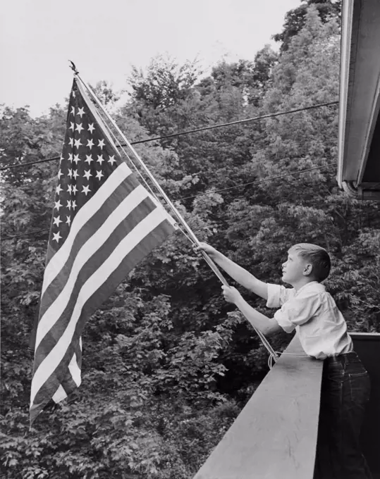 Boy holding an American flag, USA