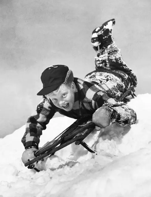 Close-up of a boy sledding on snow