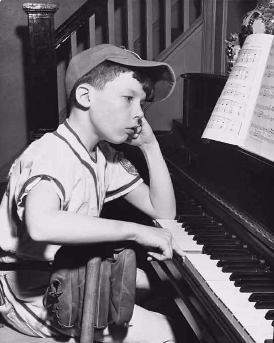 Side profile of a boy playing a piano