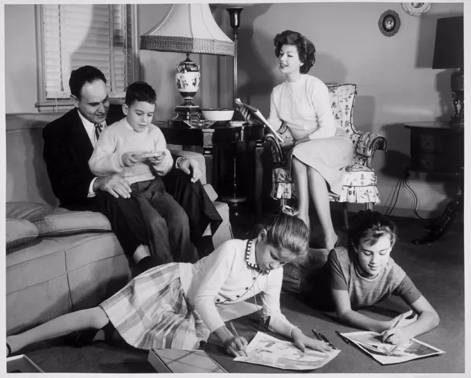 Parents and their children sitting in the living room