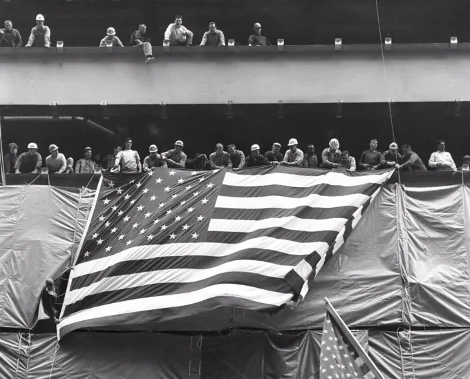 Low angle view of a crowd holding an American flag, USA