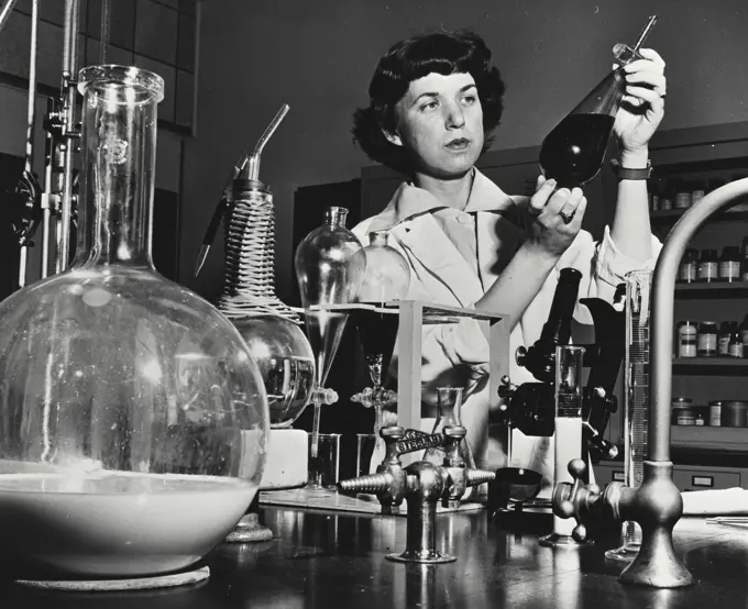 Vintage photograph. Research chemist making physical tests on oils and other organic materials at the manufacturing research laboratories