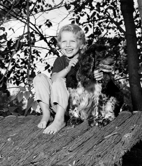 Girl with dog sitting on shed roof