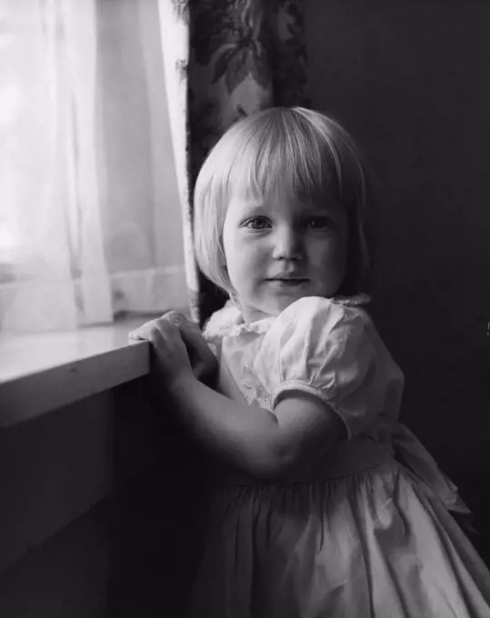 Little girl near window