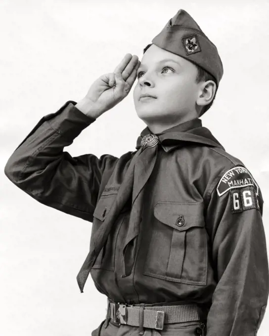 Close-up of a boy scout saluting