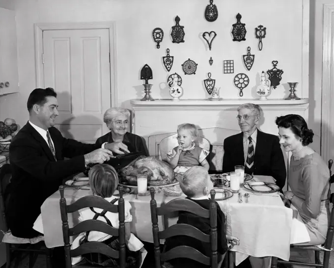 Family at a dining table on Thanksgiving Day