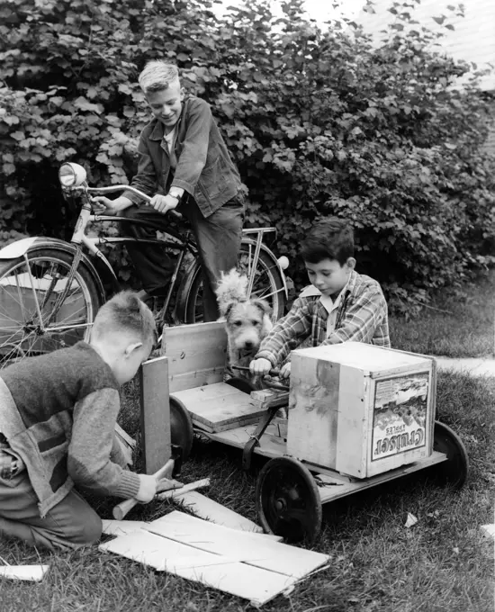 Vintage photograph of boys making gocart