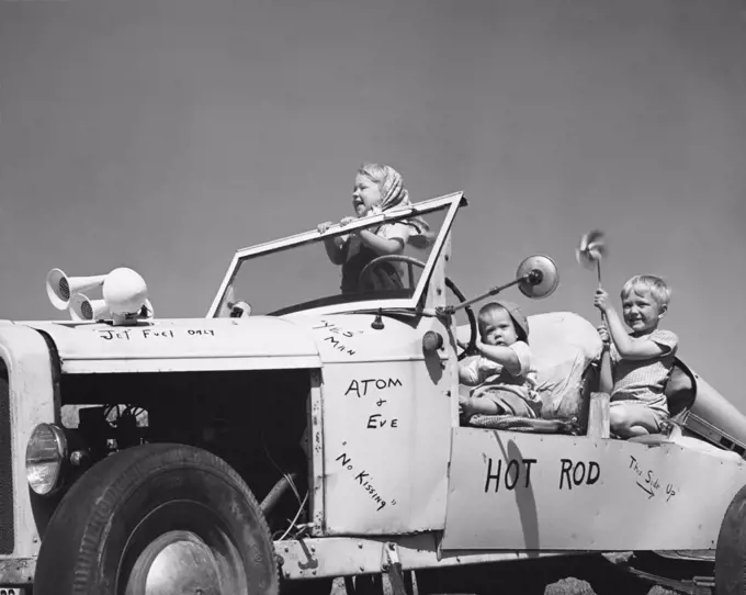 Side profile of three children sitting in a car