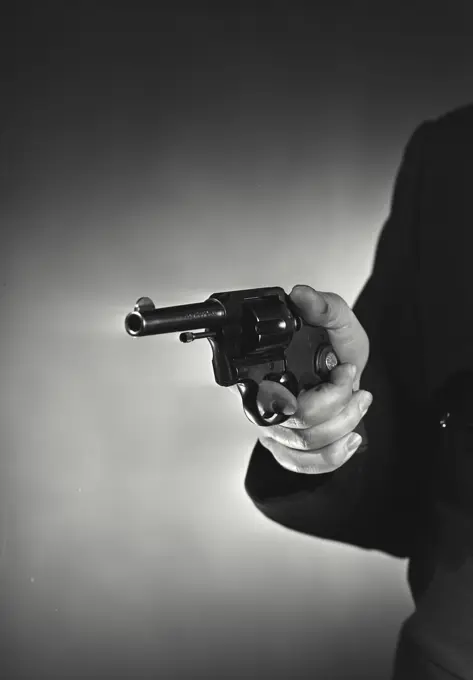 Vintage Photograph. Close-up of hand holding handgun