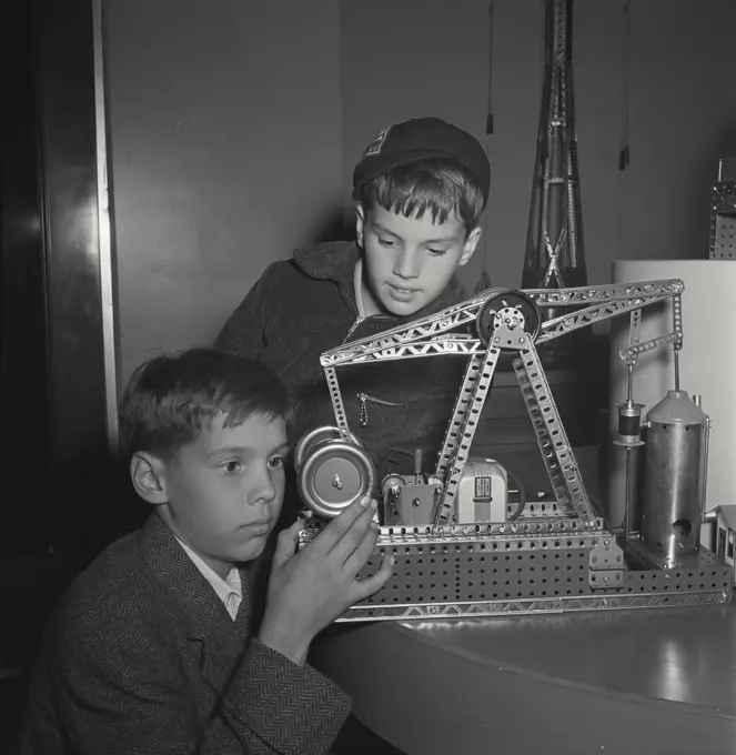 Vintage photograph. Two young boys playing with erector set