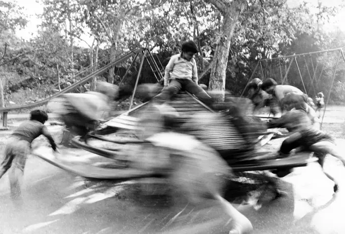 Children on spinning merry-go-round