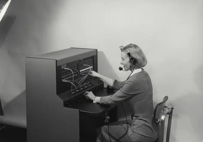 Vintage Photograph. Blonde woman switchboard operator smiling wearing headset, Frame 2