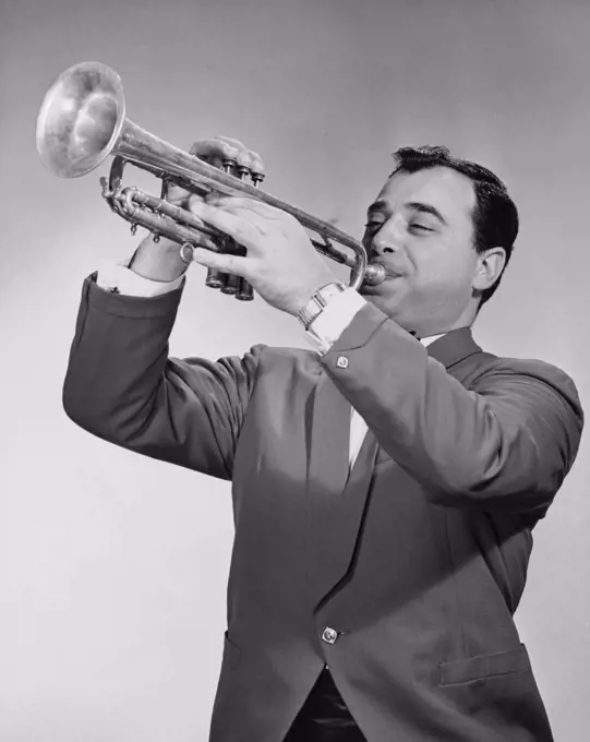 Mid adult man playing a trumpet