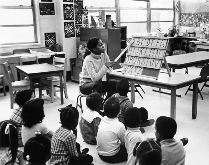 Teacher teaching her students in a classroom