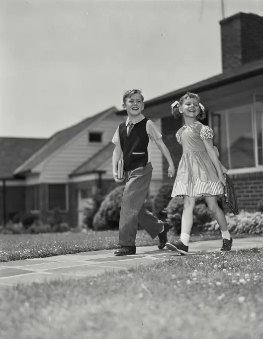 Vintage Photograph. Young boy and girl walking down path together. Frame 8