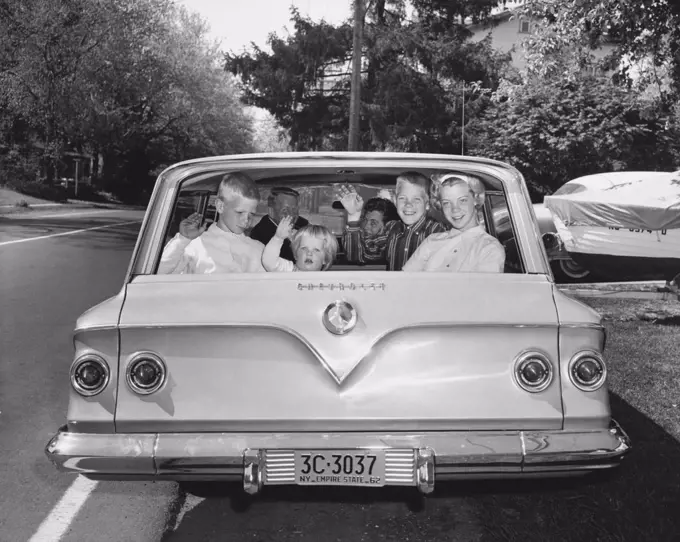 Parents with four children traveling in car