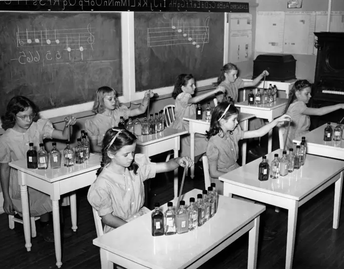 Group of school girls sitting in a music class