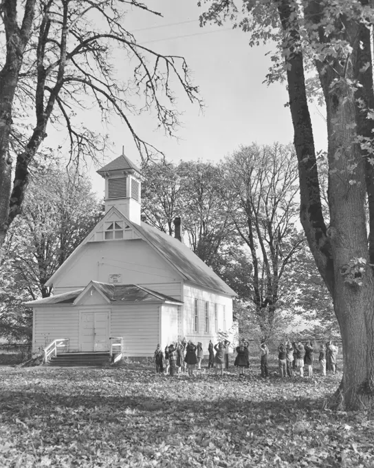 School children standing in front of their school building