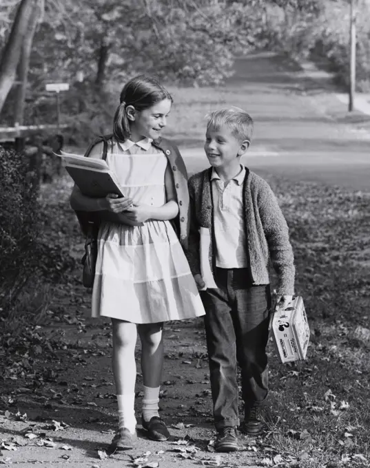 Boy and a girl walking home from school