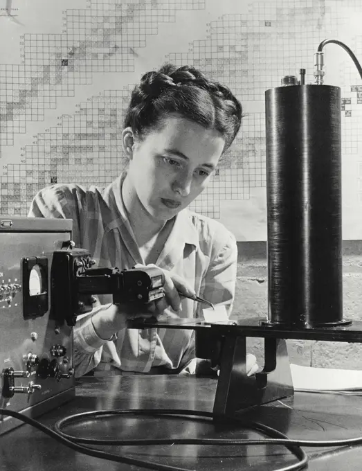 Vintage photograph. White square of paper, containing smear from object suspected to be contaminated, is analyzed by new general electric radiation detector