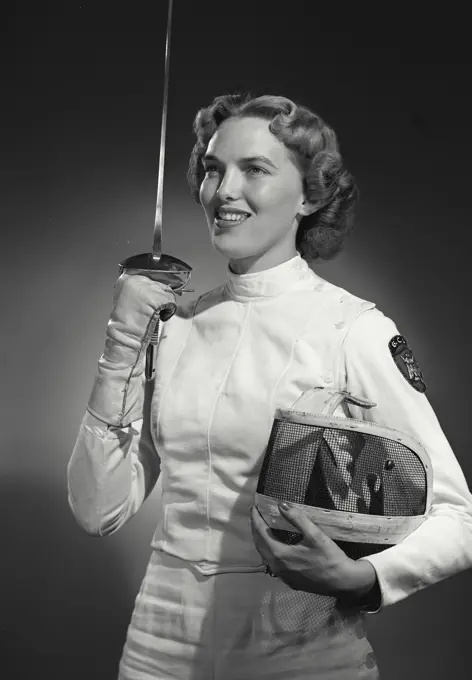 Vintage Photograph. Woman in fencing gear holding saber and facemask. Frame 2