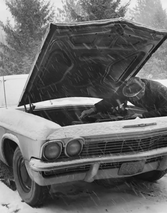 Auto mechanic repairing a vintage car