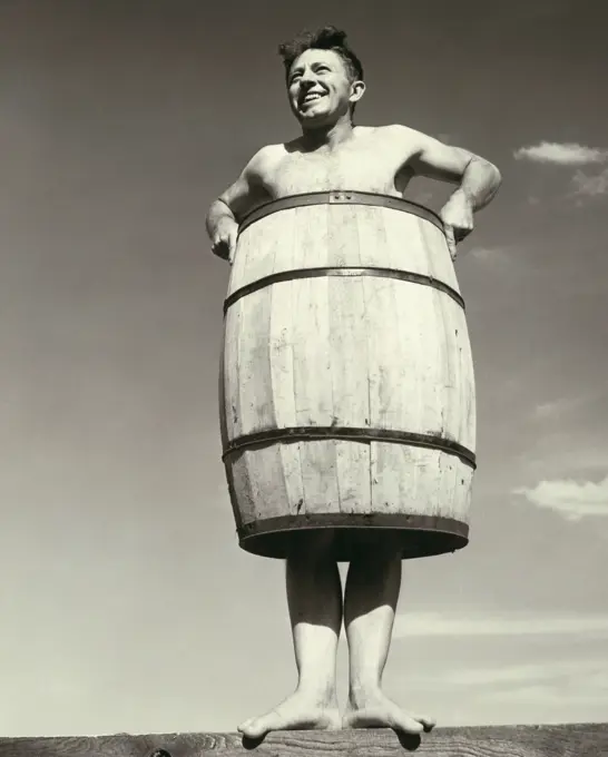 Low angle view of a young man wearing a barrel