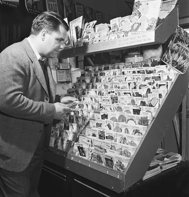 Vintage photograph. Man buying seeds in store, model released