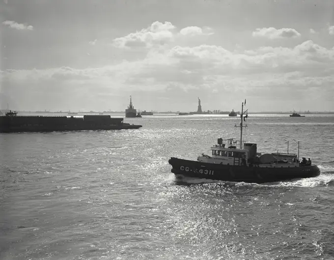 Vintage photograph. Traffic on the waters of New York Harbor with Statue of Liberty in background