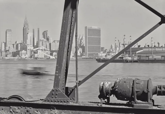 Vintage photograph. View of United Nations Building and Manhattan from structure in East River