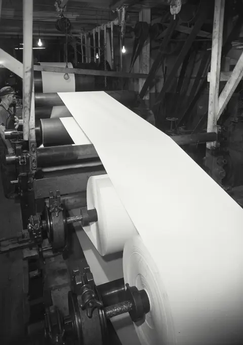 Vintage photograph. View showing a coating operation of a paper machine