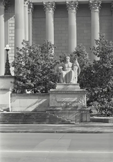 Vintage photograph. Statue in front of the National Archives Building