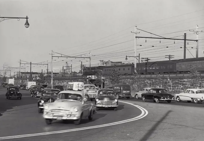 Vintage photograph. Cars driving on road in Newark