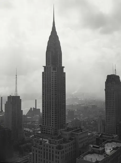 Vintage photograph. Looking south east across Mid Town Manhattan with Chrysler Building in center and Daily News Building on the left with television transmitting antenna on its roof