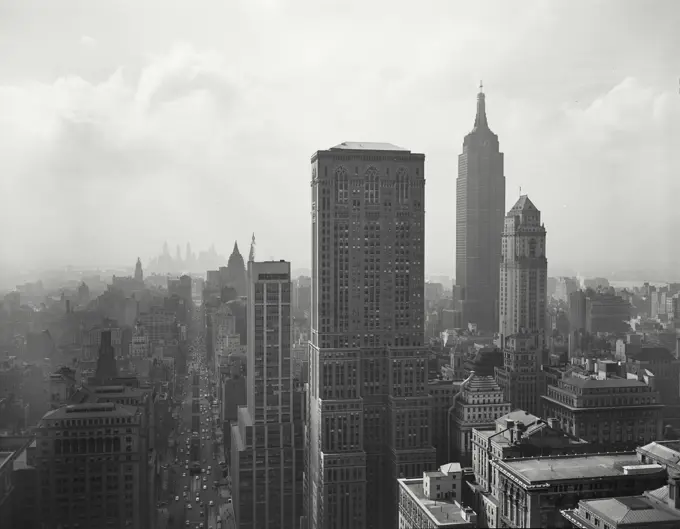 Vintage photograph. View of Manhattan skyscrapers and Park Avenue from rooftop with Empire State building on the right.