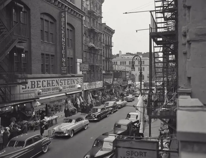 Vintage photograph. Looking south along Ludlow Street showing sidewalk shops and tenement houses, New York City