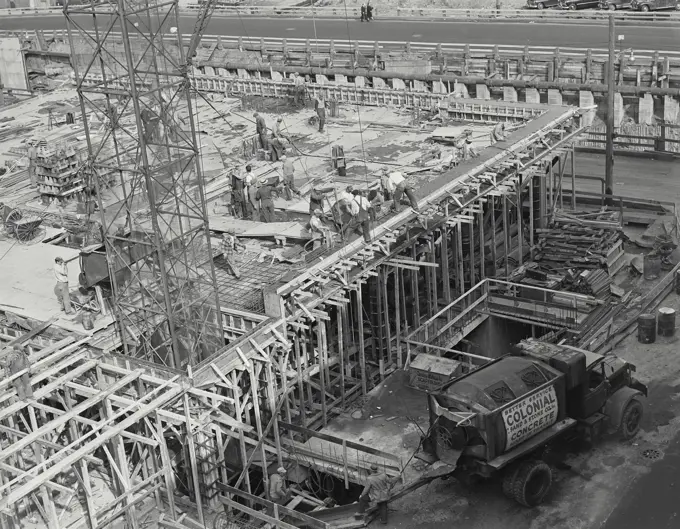 Vintage photograph. Truck pouring concrete at construction site.